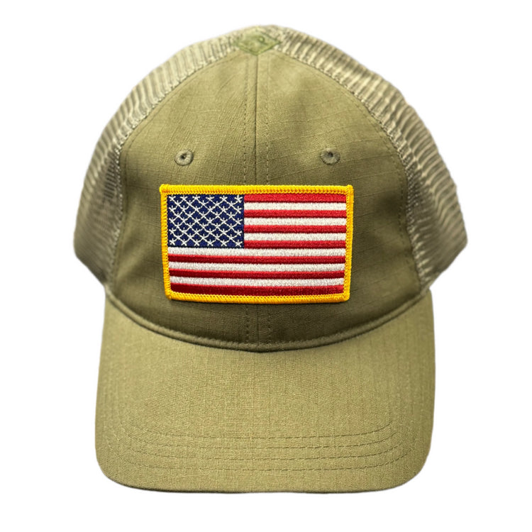 Green cap with American flag patch on a textured surface