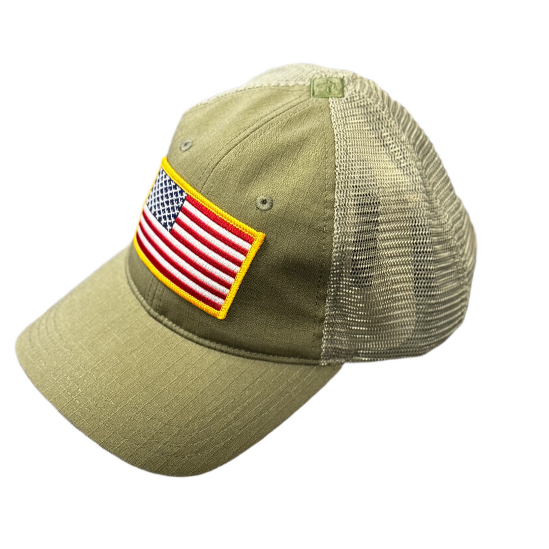 Green cap with American flag patch on a textured surface
