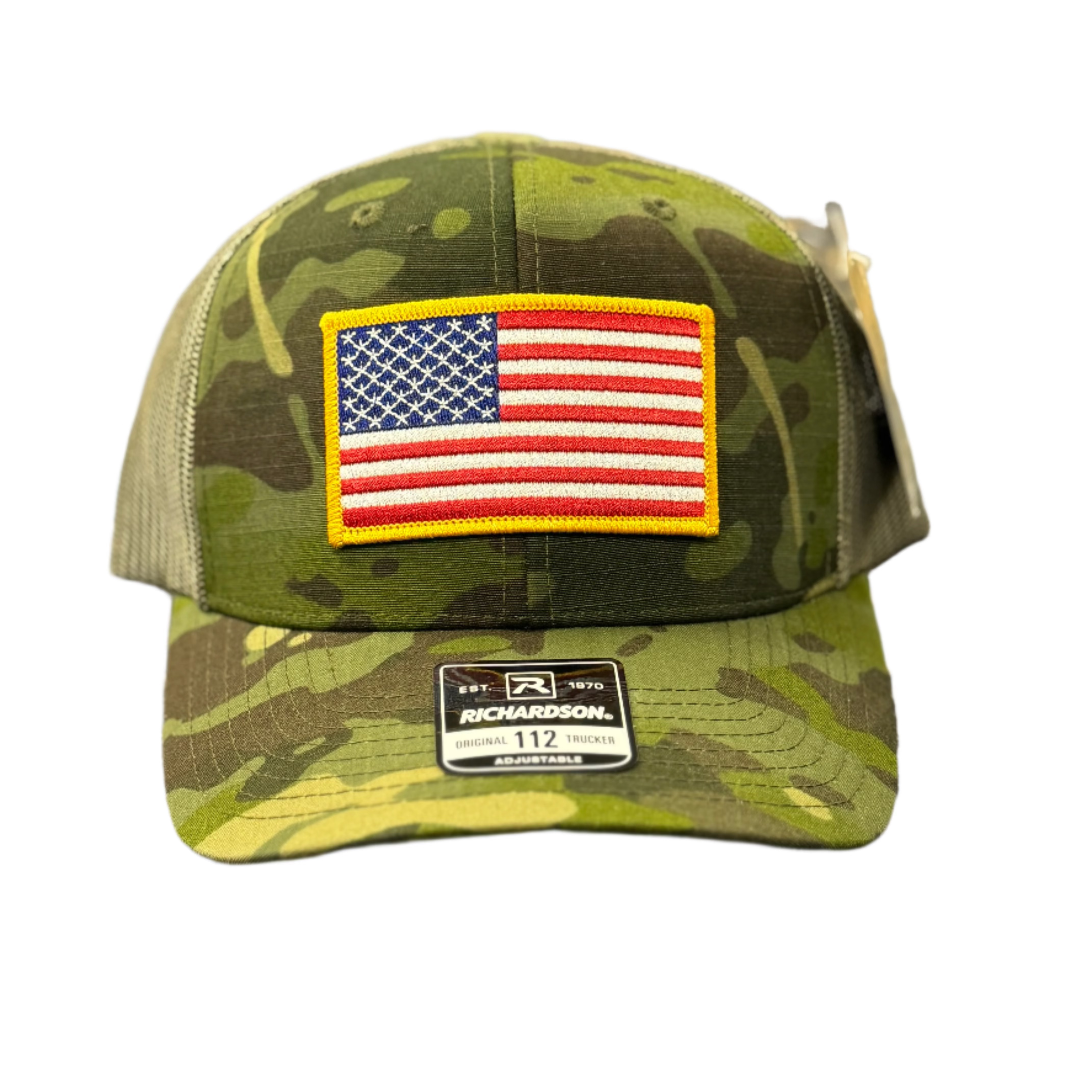 Camouflage cap with American flag patch on a textured surface